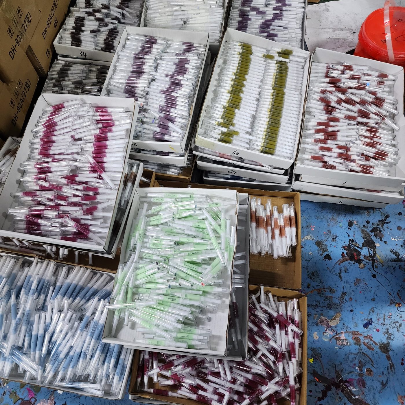 Boxes of water-based nail polish twist pens in many shades, ready for worldwide shipping